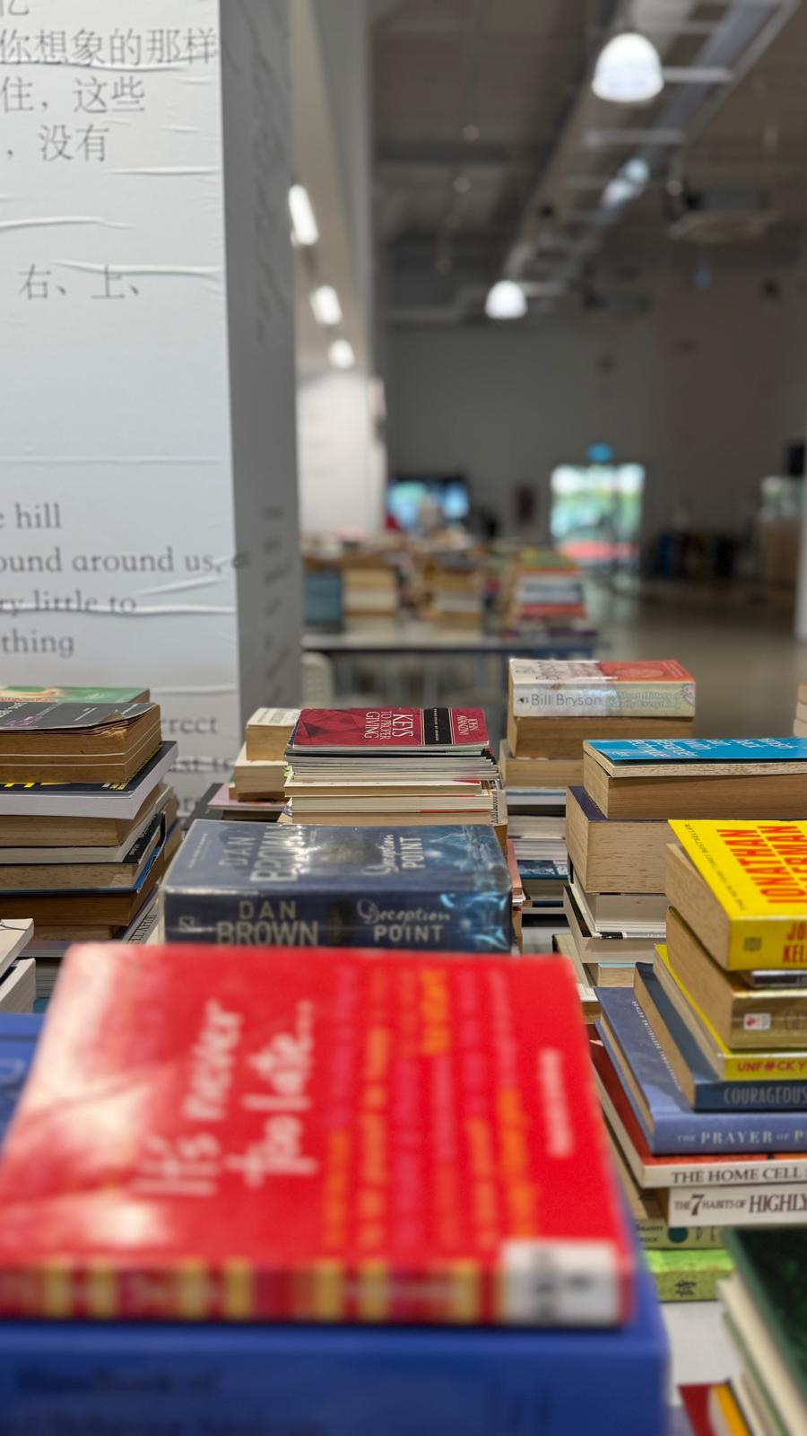 Books laid out across the tables at The Library of Unread Books